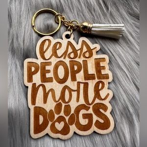 Handmade wood keychain with tassel: Less people more dogs.